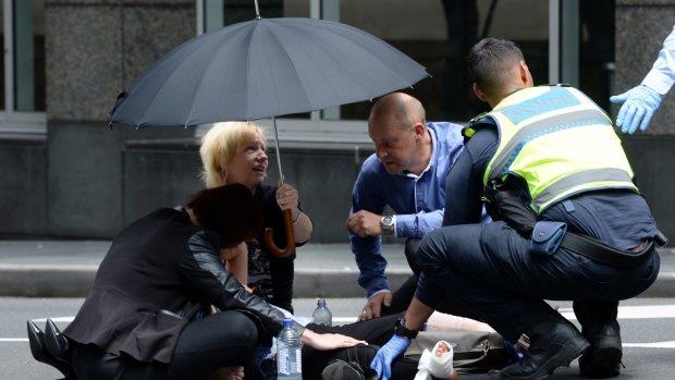 Bystanders comforted the injured in Bourke Street.