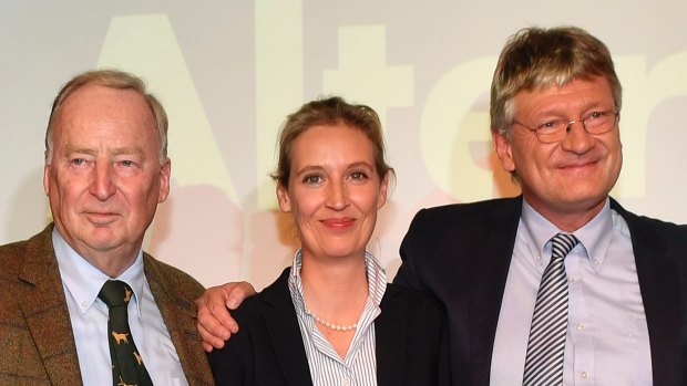 AfD top candidates Alexander Gauland, left, Alice Weidel and co-chairman Joerg Meuthen, right, celebrate with their supporters during the election party of the nationalist 'Alternative for Germany', AfD, in Berlin.