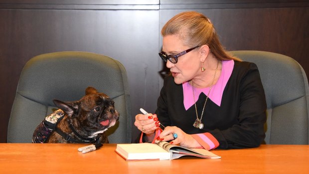 Carrie Fisher and her dog Gary Fisher sign copies of her new book <i>The Princess Diarist</i> in Los Angeles on November 28.
