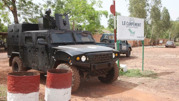 A Malian police officer stationed on an armoured personnel vehicle outside Campement Kangaba, Bamako.