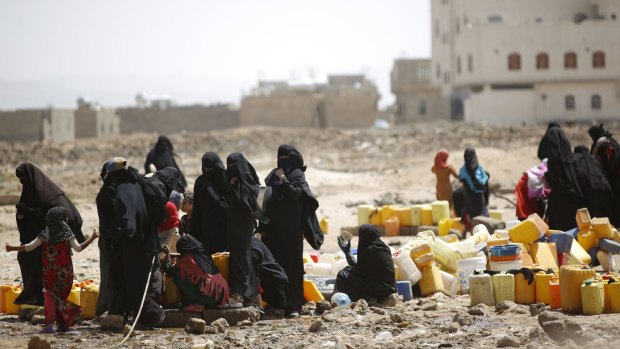 Women and children fill buckets with water from a public tap amid an acute shortage of water, on the outskirts of Sanaa earlier this month. 