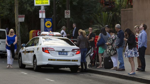 People queue for taxis at circular quay in Sydney.