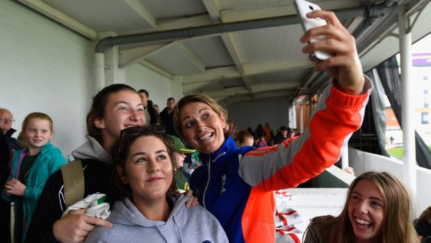 England captain Charlotte Edwards poses for selfies with fans after wet weather delayed the third one-day international of the Women's Ashes series between England and Australia at New Road in Worcester.