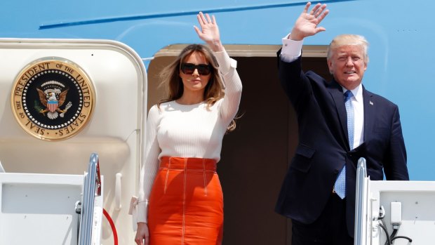 Donald Trump and first lady Melania Trump, wave as they board Air Force One for his first overseas trip as President.