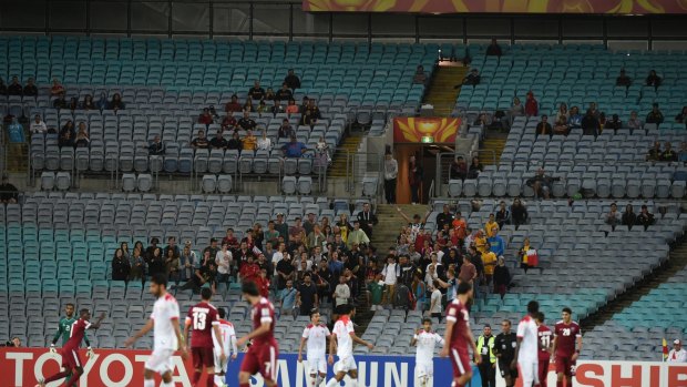For the true believers: Qatar and Bahrain play to a mostly empty arena at Stadium Australia. 