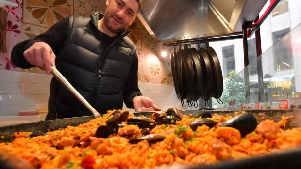 John Kyzintas makes another giant paella at Simply Spanish's Bourke Street restaurant on Monday.