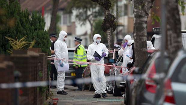 Forensic investigators prepare to examine a property in Edmonton where the woman was found dead.