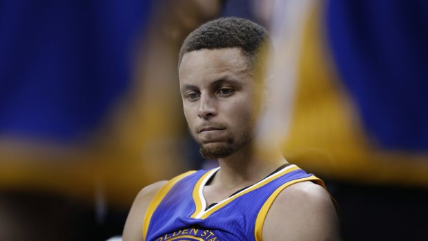 Well below his best: Golden State Warriors guard Stephen Curry sits on the bench during the second half.