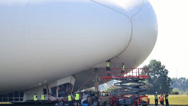 The Airlander 10, is examined as it sits on the ground after a slow crash on Augusr 24, 2016.