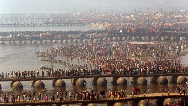 Hindu devotees walk across pontoon bridges to take a holy dip at Sangam, the confluence of the Ganges, Yamuna and mythical Saraswati River, during the Maha Kumbh festival, in Allahabad, India.
