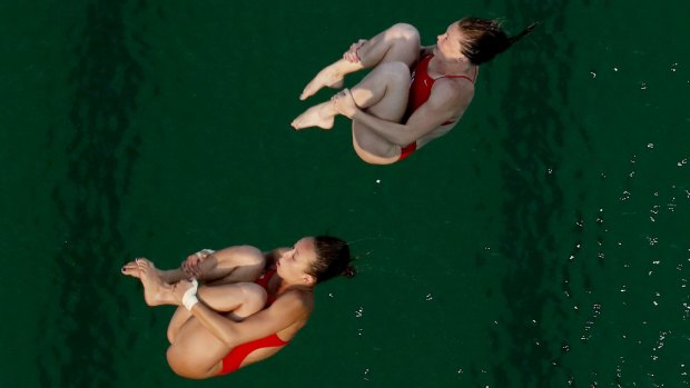 "It's so green": United States' Amy Cozad, top, and Jessica Parratto before diving into the green pool.