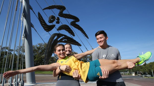 Heavy lifting: Melissa Wu is lifted by siblings Joshua and Madeline.