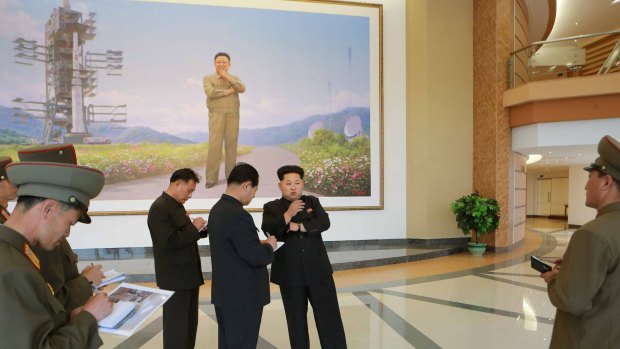 North Korean leader Kim Jong Un (centre R) at the newly built National Space Development General Satellite Control and Command Centre.