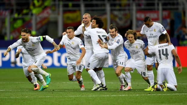 Victory: Real Madrid players celebrate after winning the Champions League final.