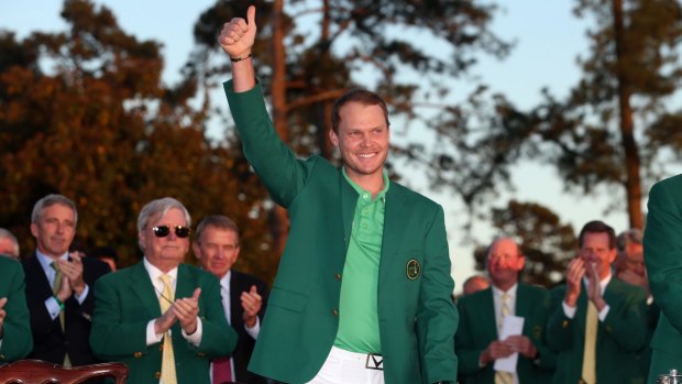 On the rise: Danny Willett celebrates his victory at Augusta.