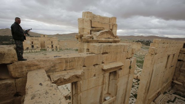 A Syrian policeman standing on the sanctuary of Baal in Palmyra last year. Such sites are often portrayed by Islamic State militants as idolatrous and destroyed.