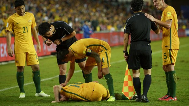 Tim Cahill shows his concern for Robbie Kruse after the horror tackle in the second half.