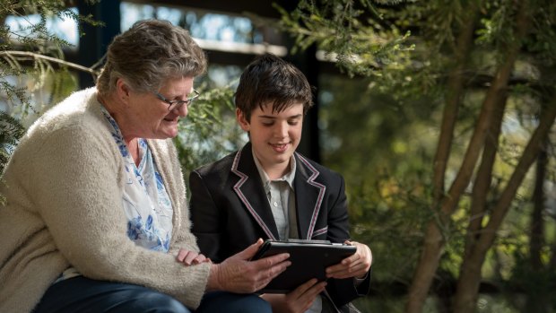 Ben, a student at Mount Eliza Secondary College teaching Jann Bell how to listen to the radio via her iPad. 