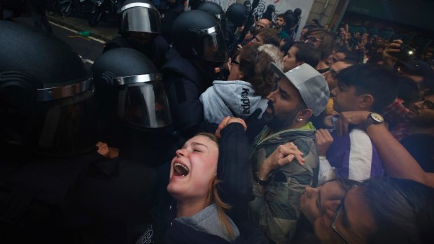 'A trap': Police push away Pro-referendum supporters outside the Ramon Llull school in Barcelona.