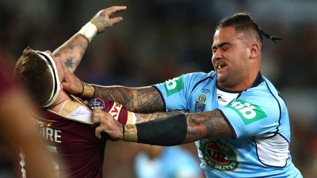 Andrew Fifita of the Blues fends Josh McGuire of the Maroons.