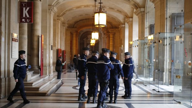 French gendarmes patrol in the Paris hall of Justice  on Wednesday while Frenchman Reda Kriket is questioned by a magistrate.