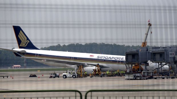 A Singapore Airlines Airbus A330-300 is seen collapsed at Changi Airport.