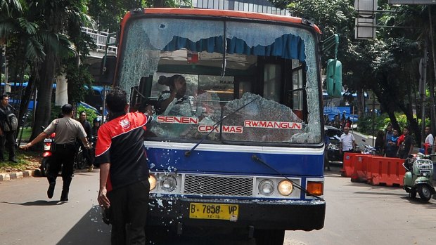 A bus windshield destroyed during mass strikes against public transport apps in Jakarta.