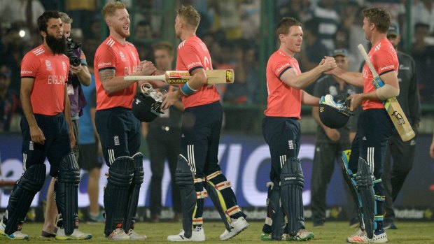 Jos Buttler and Joe Root of England celebrate with Ben Stokes and captain Eoin Morgan after winning the semi-final against New Zealand.