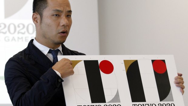 Japanese designer Kenjiro Sano, pictured with the logo earlier this month.