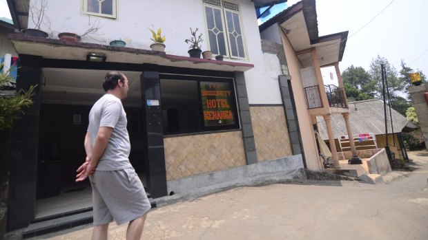 Afghan asylum seeker Muhammad Taqi walks outside the Hotel Kenanga in Cisarua. 