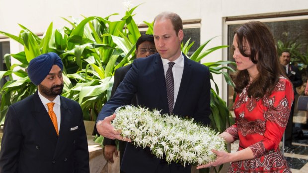 The Duchess of Cambridge wears red Alexander McQueen to lay a wreath at Taj Hotel.