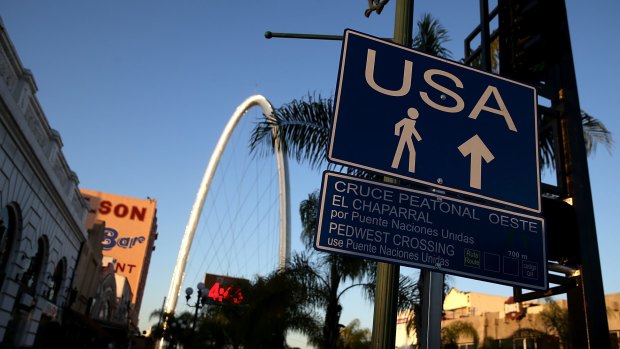 A sign directs pedestrians to the US border crossing in Tijuana, Baja California.