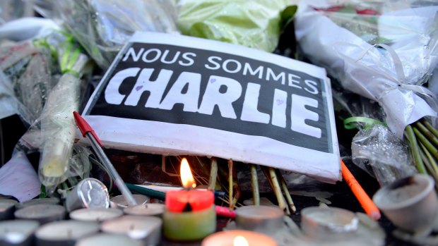 Tributes of drawings, flowers, pens and candles are left in front of the Charlie Hebdo offices following the attack.