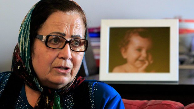 Ibtisam Berri with a picture of her granddaughter Lahala Elamine, at her home in the southern suburbs of Beirut.