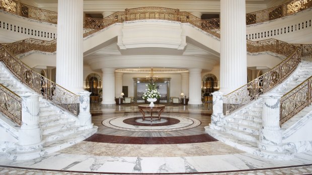 A white marble double grand staircase dominates the looby of the St Regis.
