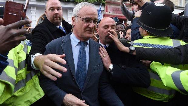 Mobbed: Claudio Ranieri leaves San Carlo Pizzeria after a celebratory lunch in Leicester.