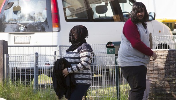 Family members leave the home of Habib Ali in Perth Street, West  Heidelberg on Wednesday morning.