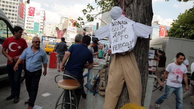 People pass by an effigy of Fethullah Gulen with a sign that reads "The traitor, FETO"  - a reference to the alleged terrorist organisation which the Turkish government blames for July's attempted coup.