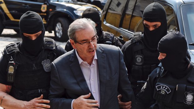 Eduardo Cunha, former speaker of Brazil's lower house, is escorted by federal police. He is serving a 15-year jail sentence for corruption.