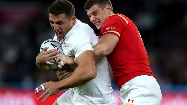 Sam Burgess is tackled by Scott Williams during the match between England and Wales.