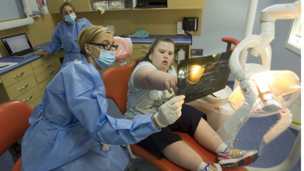 Special needs dentist Dr Helen Marchant sits with Jessica Younghusband, 26. Jessica has a painful cavity in her mouth and will need surgery. 