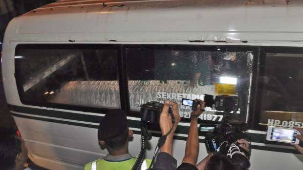 An ambulance carrying the body of convicted drug smuggler Namaona Denis, from Malawi, arrives at the port of Wijayapura in Central Java on Sunday.