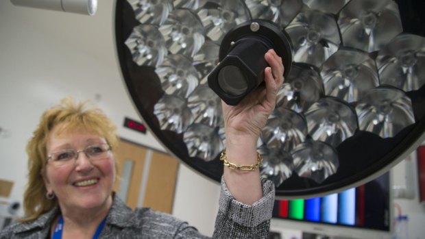 Barb Collins points out a high-definition camera built into a surgical light at the Humber River Hospital. The camera can transmit the surgery to specialists who are not in the operating room.