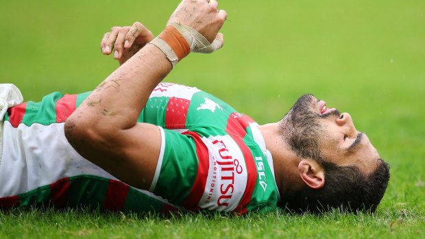 Decked: Greg Inglis of the Rabbitohs after sustaining a hard tackle.
