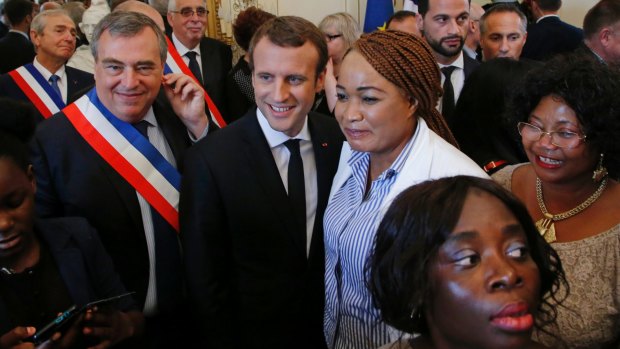 French President Emmanuel Macron with people who became French citizens during a citizenship ceremony in Orleans on Thursday.