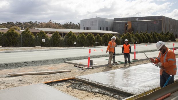 Workers laying track slab on the Gungahlin stretch of Canberra's light rail. 