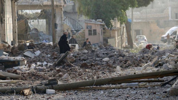 People inspecting damage from airstrikes on Atareb, in the opposition-held countryside outside Aleppo on Monday.