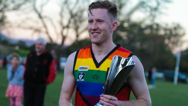 Jason Ball, the first openly gay Aussie Rules footballer, with the Pride Cup.