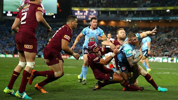 Brought down: Josh Dugan is tackled during game three.