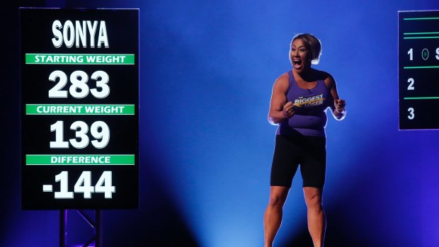 An American <i>Biggest Loser</i> contestant celebrates her weigh-in. 